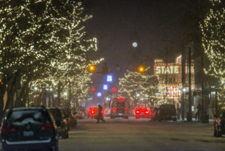 Snowy street scene at night, Traverse City, Michigan, USA