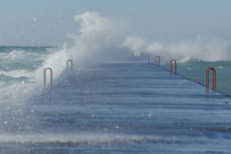 Waves crashing on dock, Lake Michigan, Frankfort, Michigan, USA