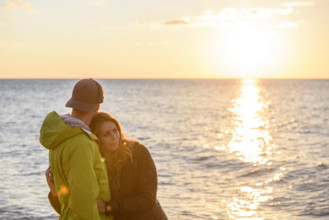 Affectionate couple enjoying sunset at beach