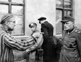 Russian slave laborer among prisoners liberated by U.S, 3rd Armored Division pointing out former