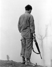 Member of the U.S. 5th Infantry Division (Mechanized) looking out over fog-shrouded A Shau Valley,