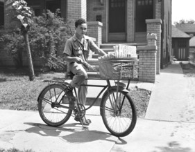Newsboy delivering newspapers, Detroit, Michigan, USA, Arthur S. Siegel, U.S. Office of War