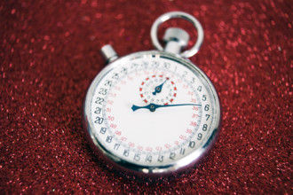 Stop watch on sparkly red background