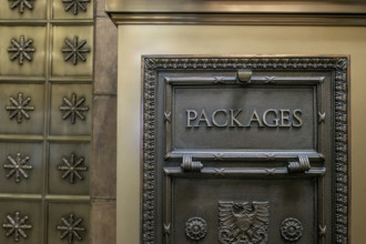 Vintage cast metal package box in office building lobby