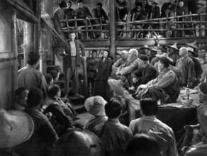 Turhan Bey (standing on steps), Katharine Hepburn (standing right of Bey), on-set of the film,