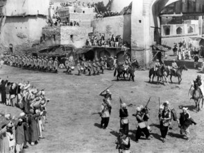 Scottish regiment marching into Indian village, on-set of the British film, "The Drum", U.S. title: