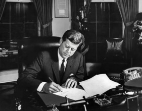 U.S. President John F. Kennedy signing the Interdiction of the Delivery of Offensive Weapons to