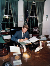 U.S. President John F. Kennedy signing the Interdiction of the Delivery of Offensive Weapons to
