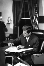 U.S. President John F. Kennedy signing the Interdiction of the Delivery of Offensive Weapons to