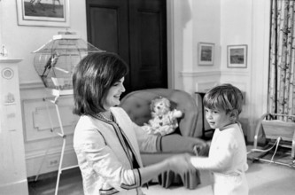 U.S. First Lady Jacqueline Kennedy playing with her son, John F. Kennedy, Jr., in John’s nursery,