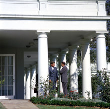 U.S. President John F. Kennedy speaking with U.S. Secretary of Defense Robert S. McNamara (right)