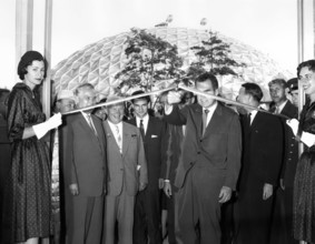 U.S. Vice President Richard M. Nixon cutting ceremonial ribbon at the opening of the American
