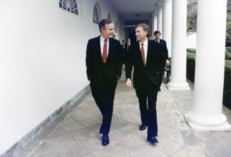 U.S. President George H.W. Bush walking along the colonnade with U.S. Vice President Quayle enroute