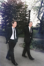 U.S. President George H.W. Bush walking up the south lawn towards the Oval Office with his son,