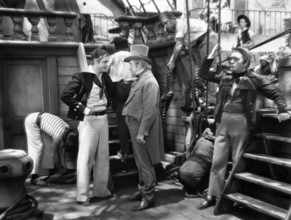 Robert Donat (left), Walter Walker (top hat), on-set of the film, "The Count Of Monte Cristo",