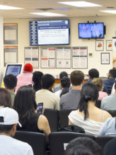 Group of people sitting in waiting area of U.S. Social Security Administration Office, New York City