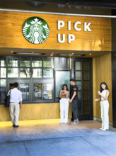 Customers waiting for their orders at service window, Starbuck's Pick Up, New York City