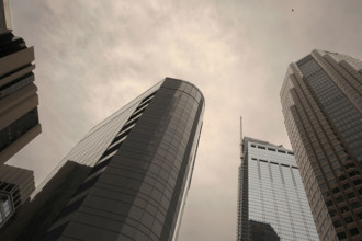 Low angle view of office buildings against cloudy sky, Los Angeles
