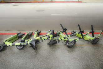 Row of fallen electric rental scooters on sidewalk, Los Angeles