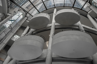 Low angle view of four oval balconies and skylight in hotel lobby