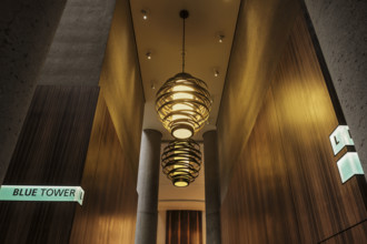 Two large spiral pendant lights in hotel lobby