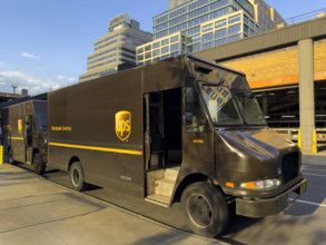 UPS delivery trucks parked on street, New York City