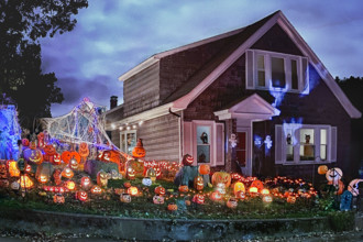 Suburban home decorated with many festive Halloween decorations.