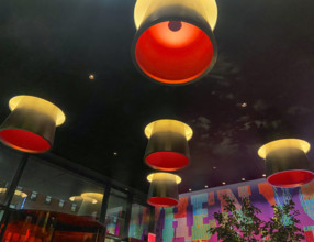Low angle view of illuminated ceiling lights of modern hotel lobby