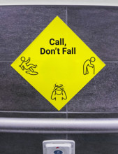 Yellow call for help sign in hospital bathroom