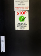 Proof of vaccination sign on freight entrance door, New York City