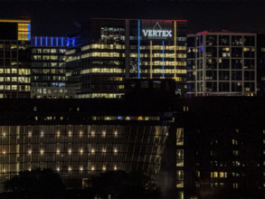 Cityscape featuring Vertex corporate office building at night, Boston