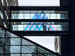 Silhouette of unidentifiable person on pedestrian bridge linking two buildings, Mount Sinai Hospital, Manhattan, New York City