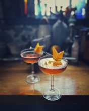 Two cocktails on counter of a home bar