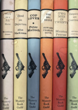 Row of mystery and crime novels on bookshelf
