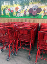 Rows of red shopping carts at supermarket