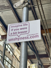 Advertising placard attached to building scaffold, New York City