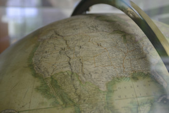 Western and Central United States on vintage globe with Mexico, Baja Mexico, and Gulf of Mexico at bottom, Pacific Ocean on right, Canada on top
