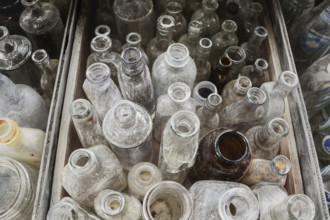 Assorted collection of old glass bottles for sale at roadside antique shop