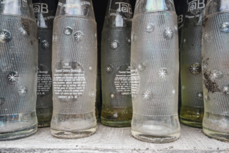 Old Tab soda bottles for sale at a roadside antique store