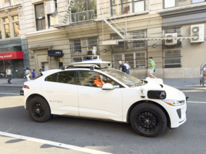 Waymo driverless test car, a Jaguar I-PACE electric vehicle and street scene, Manhattan, New York