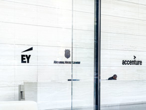 Lobby view with signs for offices of EY, National Hockey League, Accenture, One Manhattan West