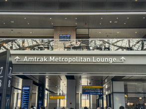 Direction sign for Amtrak Metropolitan Lounge, Moynihan Train Hall, Pennsylvania Station,