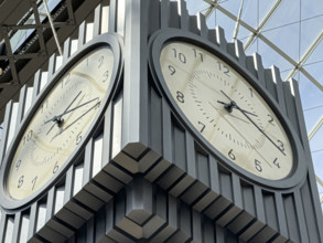 Hanging 4-sided clock above passenger concourse low angle view, Moynihan Train Hall, Pennsylvania
