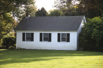 Small white house with green lawn