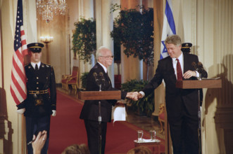U.S. President Bill Clinton shaking hands with Israeli Prime Minister Yitzhak Rabin during press