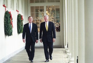 U.S. President Bill Clinton and U.S. President-Elect George W. Bush walking through White House,