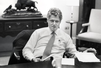 U.S. President Bill Clinton sitting at  conference table during meeting in the White House,