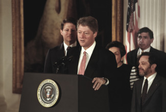 U.S. President Bill Clinton standing at podium after swearing-in the first members of his cabinet