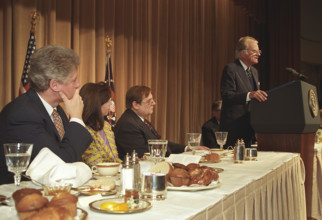 U.S. President Bill Clinton looking on as American evangelist Billy Graham is speaking at annual