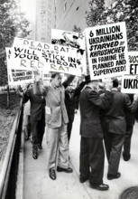 Group of people with signs protesting Soviet Leader Nikita Khrushchev's visit to United Nations,
